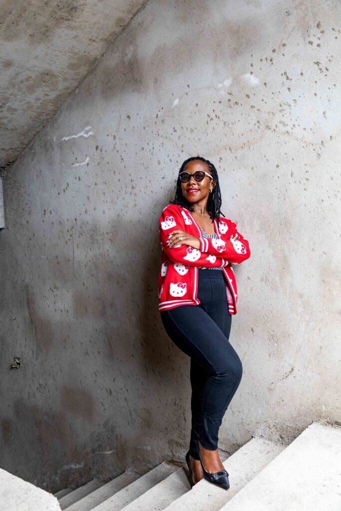 Judith Wanja (the lead architect at Guarcha Architects, a leading architecture firm in Nairobi) standing on a staircase in a house under construction